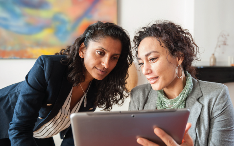 female-coworkers-reviewing-work-data-on-tablet-800x500px